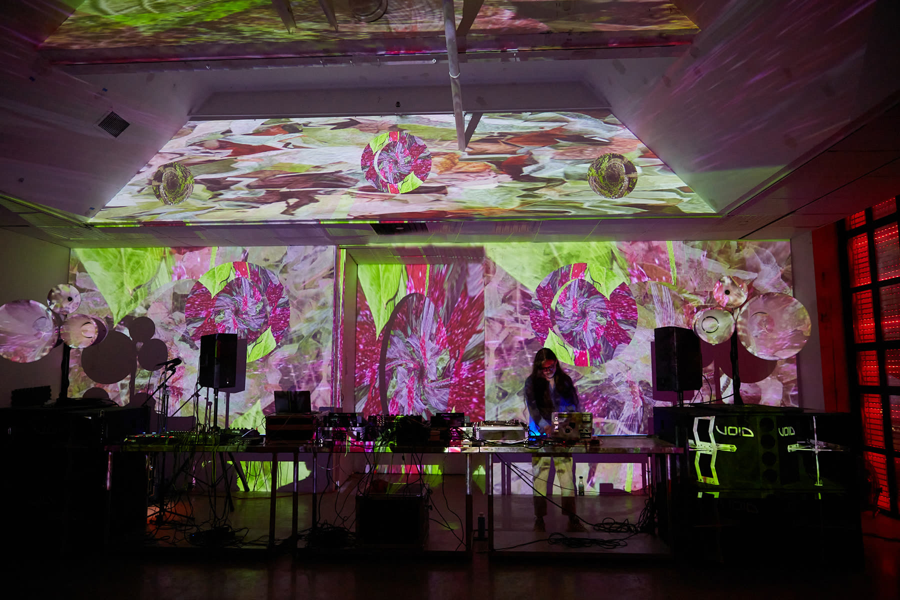 The stage end wall of the gallery mapped with projection for a past event, including the beam soffits above it